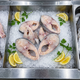 Yellow croaker fish steaks on crushed ice with lemon and parsley
