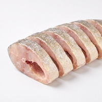 Frozen yellow croaker fish steaks, medium cut, on a white background