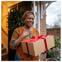 Nigerian woman receiving an African food Christmas gift hamper at her front door in the UK